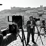 **

*   **Prompt:** Manoel de Oliveira directing on set, film crew, classic Portuguese cinema, black and white, thoughtful expression, vintage camera, Lisbon backdrop.

**